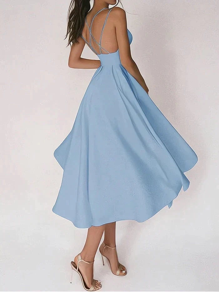 Elegantes weißes Sommerkleid mit offenem Rücken und Spaghettiträgern, kombiniert mit goldenen High Heels