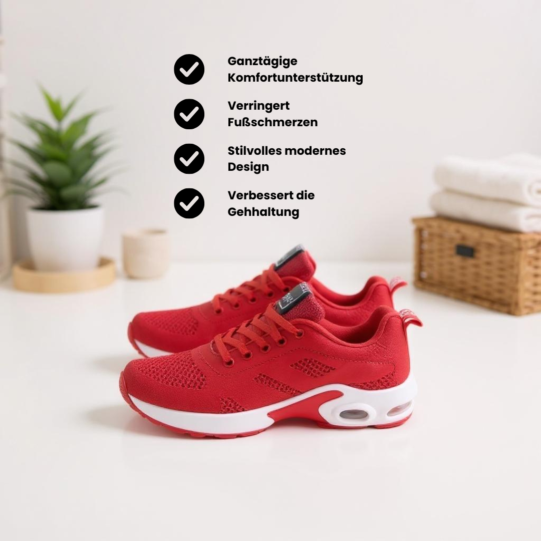Roter Sportschuh mit atmungsaktivem Mesh-Obermaterial, weißer Sohle und sichtbaren Luftpolster-Elementen, schwebend vor neutralem Hintergrund dargestellt.