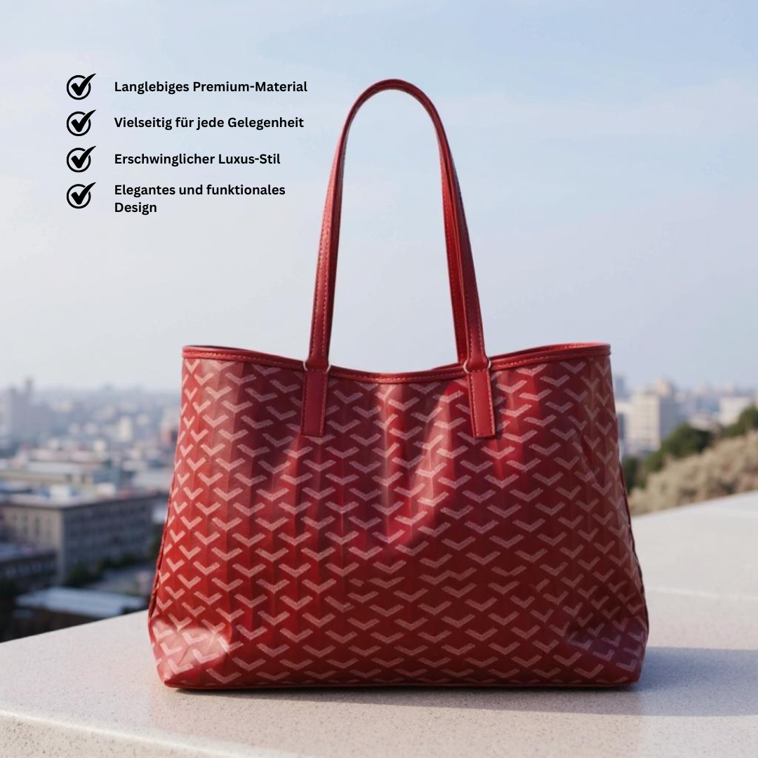 Blaue Tote Bag mit weißen geometrischen Mustern und langen Henkeln, vor hellem Hintergrund schwebend dargestellt.